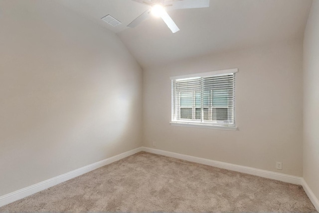 unfurnished room featuring a ceiling fan, light colored carpet, baseboards, and vaulted ceiling