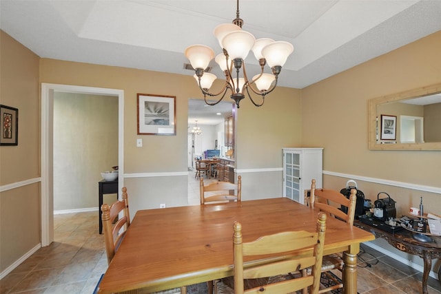 2606 N Carroll Ave, Southlake, TX 76092 - dining space with a chandelier, tile patterned flooring, and baseboards
