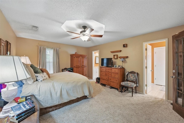 2606 N Carroll Ave, Southlake, TX 76092 - bedroom featuring carpet flooring, a textured ceiling, a ceiling fan, and connected bathroom
