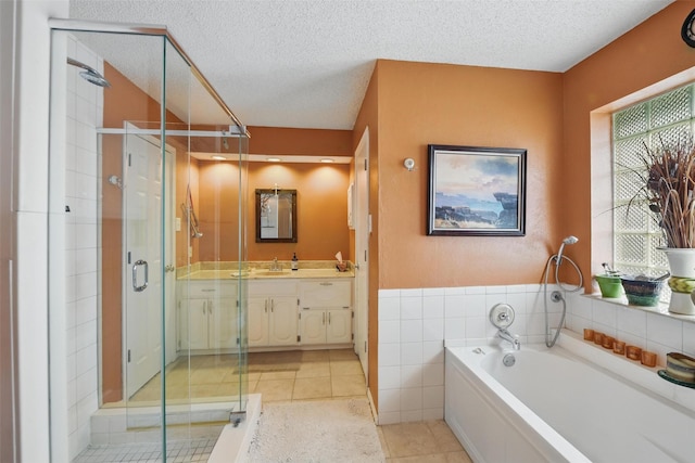 2606 N Carroll Ave, Southlake, TX 76092 - bathroom featuring vanity, a bath, a shower stall, a textured ceiling, and tile patterned floors