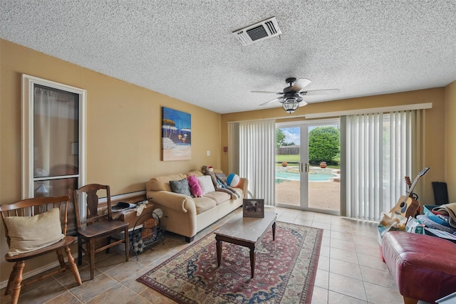 2606 N Carroll Ave, Southlake, TX 76092 - living room with light tile patterned flooring, a ceiling fan, and a textured ceiling