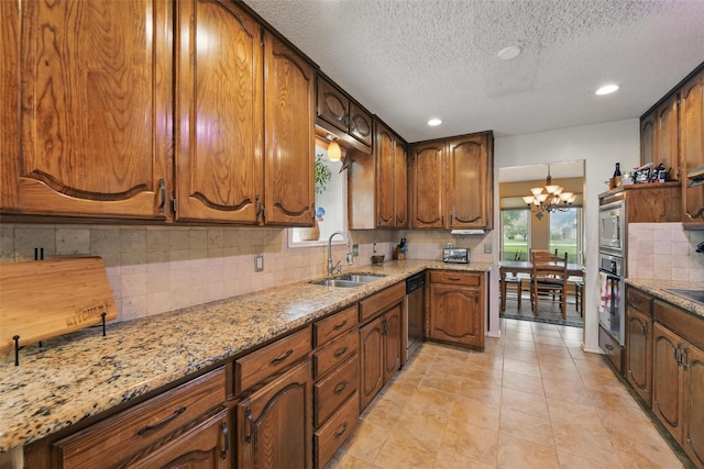 2606 N Carroll Ave, Southlake, TX 76092 - kitchen with a sink, stainless steel appliances, plenty of natural light, decorative backsplash, and a textured ceiling