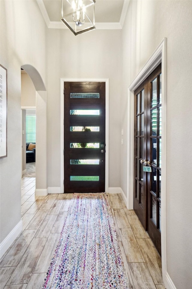 1456 Silent Springs Dr, Fort Worth, TX 76052 - foyer with french doors, crown molding, wood finished floors, arched walkways, and baseboards