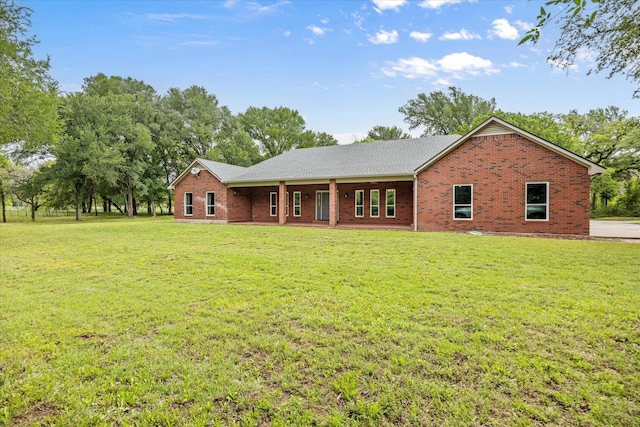 view of front of house with brick siding and a front lawn