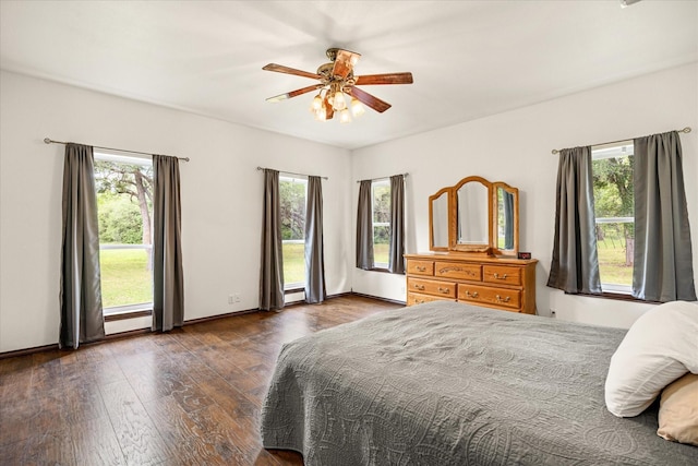 bedroom featuring multiple windows, hardwood / wood-style flooring, and ceiling fan