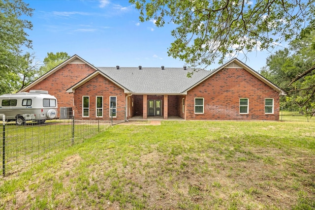 rear view of property with brick siding, a shingled roof, central AC unit, and a patio area