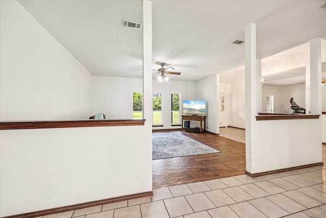 entrance foyer with ceiling fan, baseboards, and light wood finished floors