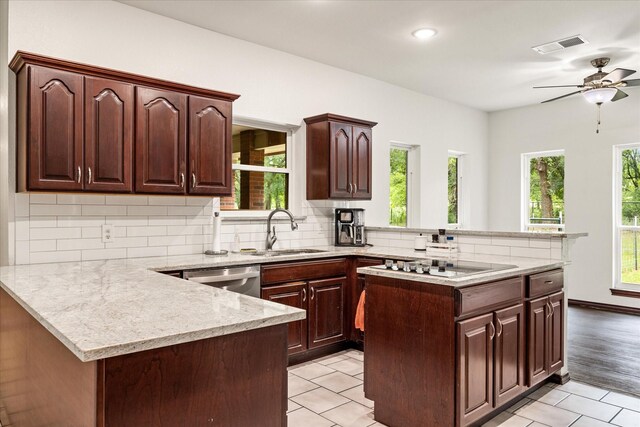 kitchen featuring a sink, a peninsula, black electric stovetop, stainless steel dishwasher, and recessed lighting