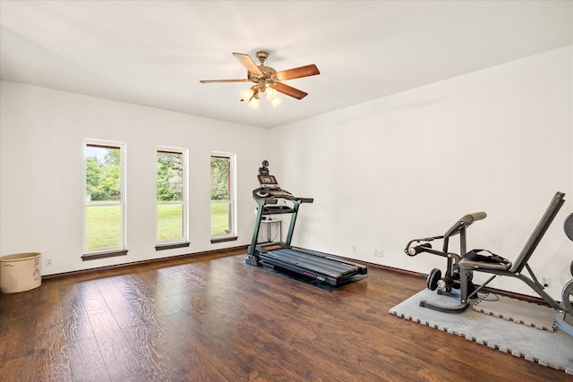 workout area featuring wood finished floors, ceiling fan, and baseboards
