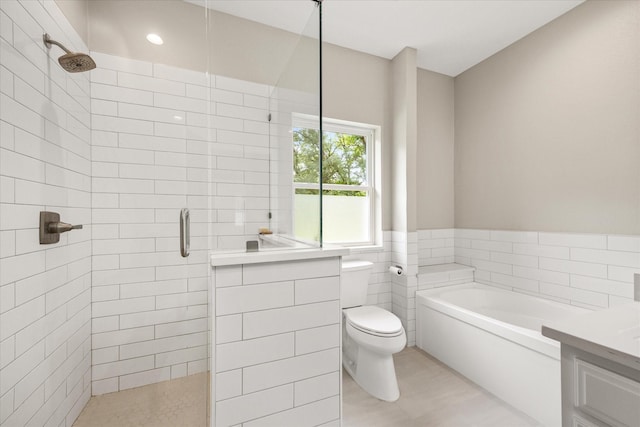 bathroom with tiled shower, toilet, a bath, tile walls, and vanity