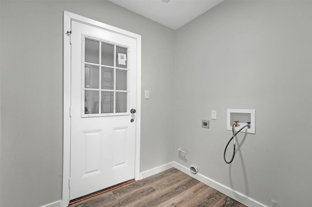 washroom featuring electric dryer hookup, wood finished floors, washer hookup, baseboards, and hookup for a gas dryer