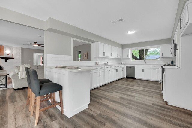 kitchen featuring appliances with stainless steel finishes, decorative backsplash, and white cabinets