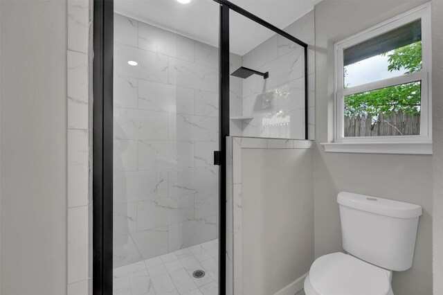 bathroom with toilet and a stall shower