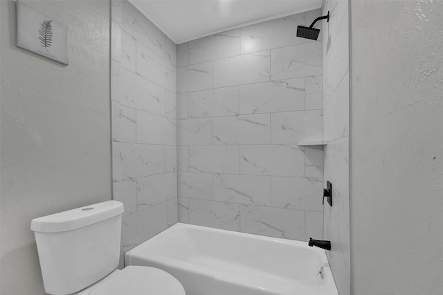 full bath featuring toilet, bathtub / shower combination, and a textured wall