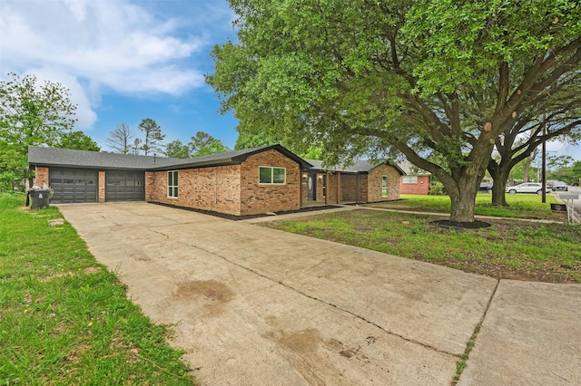 view of front of house featuring concrete driveway, an attached garage, brick siding, and a front lawn