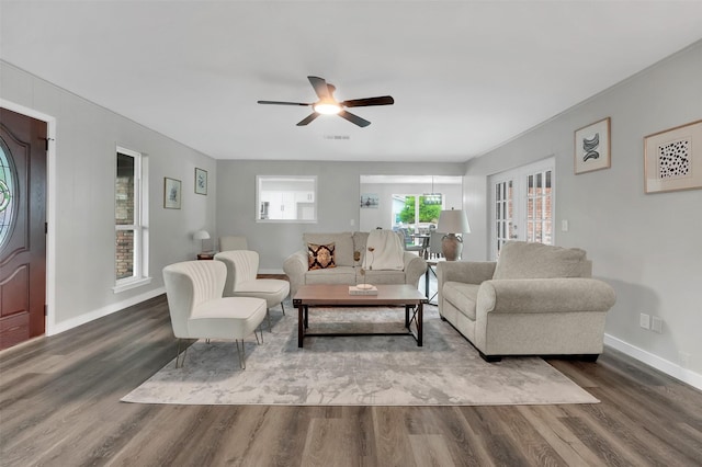 living area with wood finished floors, ceiling fan, and baseboards