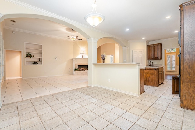 842 Turquoise Pt, Rockwall, TX 75032 - kitchen with light tile patterned floors, built in shelves, open floor plan, a ceiling fan, and a lit fireplace