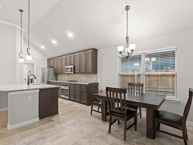 1713 Victoria Dr, Fort Worth, TX 76131 - kitchen featuring stainless steel appliances, a chandelier, backsplash, a sink, and dark brown cabinets