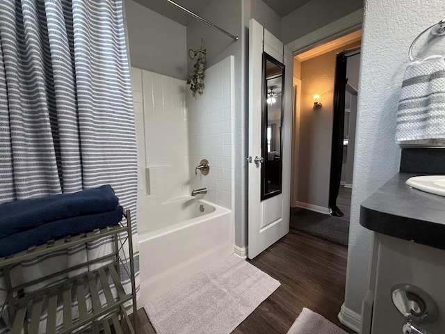 1253 E Ramsey Ave, Fort Worth, TX 76104 - bathroom featuring wood finished floors, shower / bathtub combination, and vanity