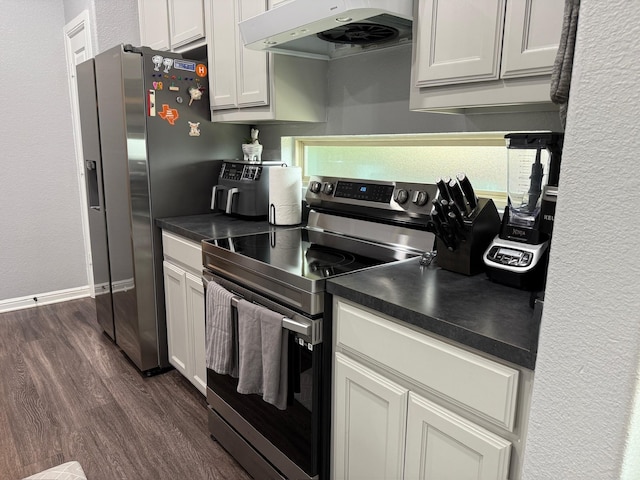 1253 E Ramsey Ave, Fort Worth, TX 76104 - kitchen with appliances with stainless steel finishes, under cabinet range hood, dark wood finished floors, dark countertops, and white cabinets