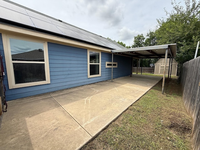 1253 E Ramsey Ave, Fort Worth, TX 76104 - view of patio / terrace featuring a storage unit, fence, and an outbuilding