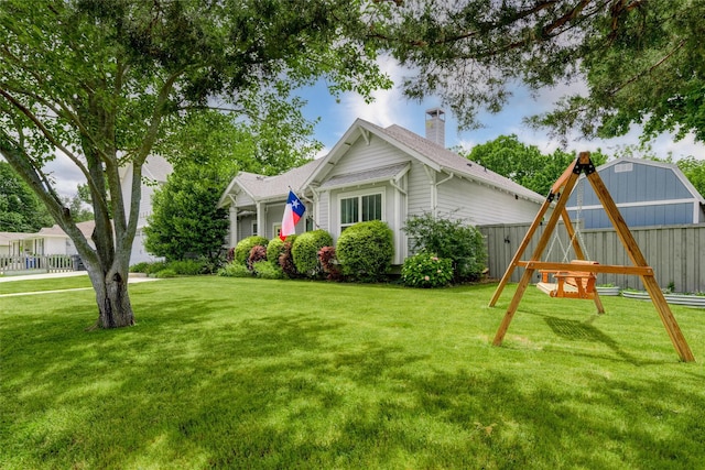 view of side of property featuring a lawn and a chimney