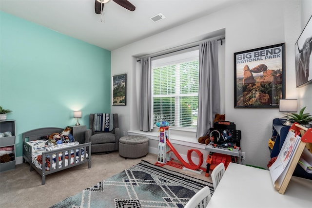 carpeted bedroom with a ceiling fan and baseboards