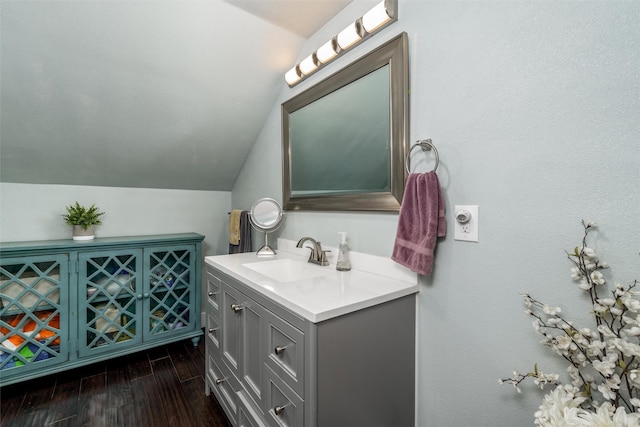 bathroom featuring vaulted ceiling, vanity, and wood finished floors