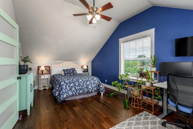 bedroom featuring lofted ceiling, wood finished floors, an office area, baseboards, and a ceiling fan