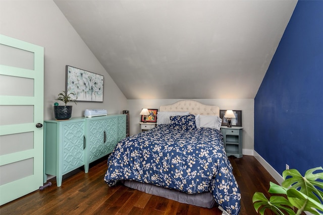 bedroom with lofted ceiling, wood finished floors, and baseboards
