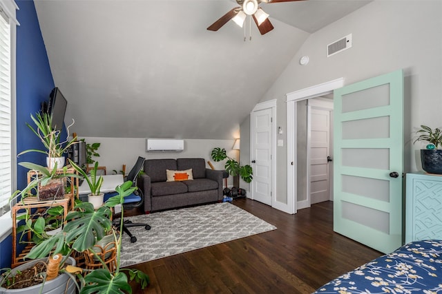 bedroom with a wall mounted AC, vaulted ceiling, wood finished floors, a ceiling fan, and baseboards