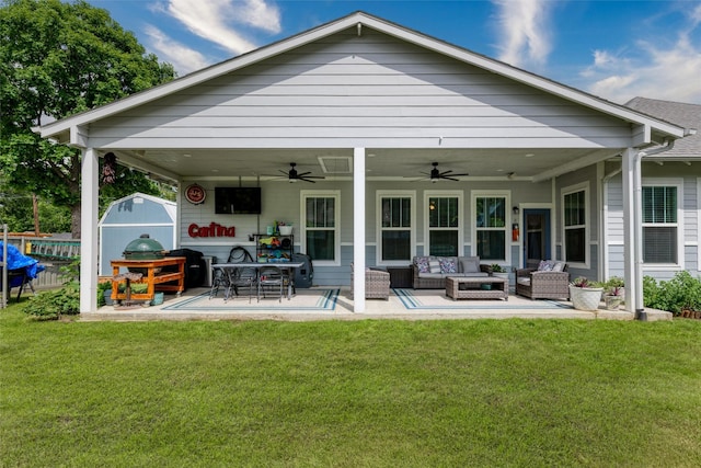 back of house featuring outdoor lounge area, ceiling fan, a storage unit, and a lawn
