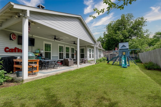 back of house featuring a playground, a ceiling fan, a patio area, and outdoor lounge area