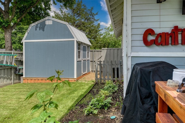view of side of property with a shed, an outbuilding, and a gambrel roof