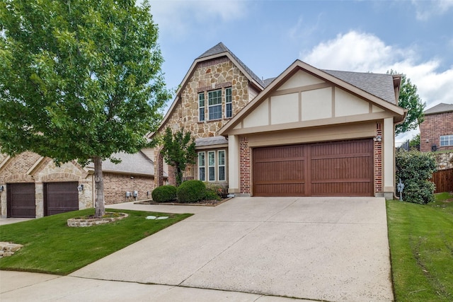 7333 Valencia Grove Ct, Fort Worth, TX 76132 - tudor house with a front lawn, concrete driveway, a garage, and stone siding