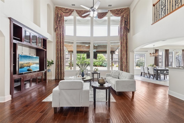 509 Wentworth Ln, Murphy, TX 75094 - living area with a ceiling fan, a high ceiling, dark wood-type flooring, arched walkways, and a chandelier