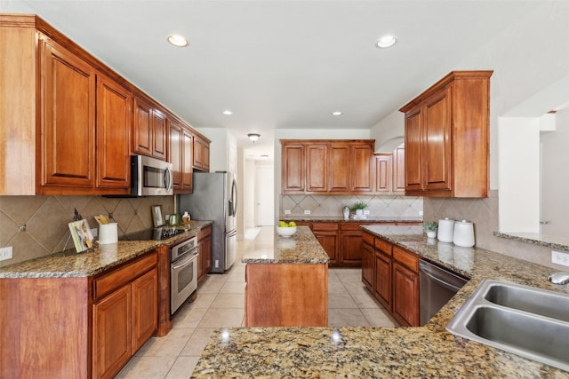 509 Wentworth Ln, Murphy, TX 75094 - kitchen featuring stainless steel appliances, a sink, decorative backsplash, light tile patterned floors, and stone countertops
