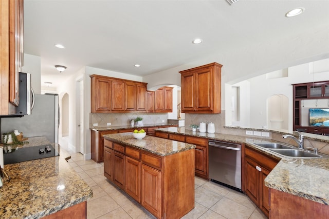 509 Wentworth Ln, Murphy, TX 75094 - kitchen featuring a sink, stainless steel dishwasher, arched walkways, backsplash, and light tile patterned floors