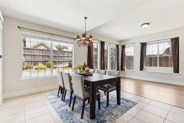 509 Wentworth Ln, Murphy, TX 75094 - tiled dining space featuring a chandelier and baseboards