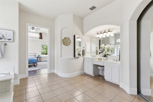 509 Wentworth Ln, Murphy, TX 75094 - bathroom with a ceiling fan, tile patterned floors, double vanity, ensuite bath, and a garden tub