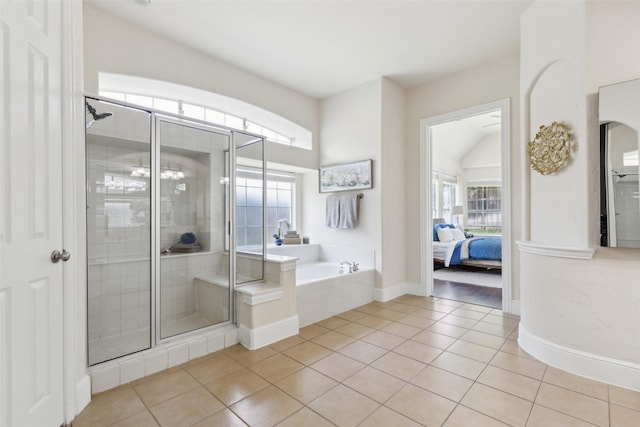 509 Wentworth Ln, Murphy, TX 75094 - ensuite bathroom with tile patterned flooring, a shower stall, a bath, and baseboards