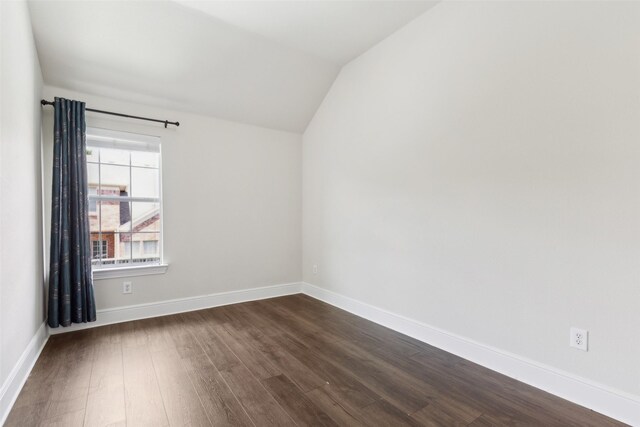 509 Wentworth Ln, Murphy, TX 75094 - unfurnished room featuring dark wood-type flooring, vaulted ceiling, and baseboards