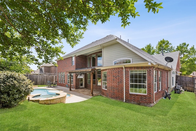 509 Wentworth Ln, Murphy, TX 75094 - rear view of house with a patio, brick siding, a pool with connected hot tub, and a shingled roof