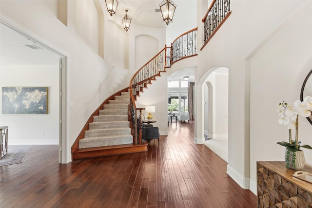 509 Wentworth Ln, Murphy, TX 75094 - foyer entrance with arched walkways, wood-type flooring, stairway, baseboards, and a high ceiling