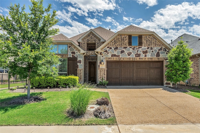 175 Calla Dr, Flower Mound, TX 75028 - view of front of house with concrete driveway, stone siding, and a garage