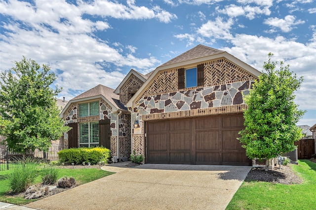 175 Calla Dr, Flower Mound, TX 75028 - english style home with driveway, a garage, fence, and stone siding