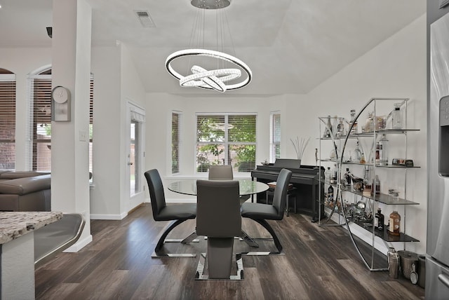 10108 Morning Glory Ln, Frisco, TX 75035 - dining area featuring a chandelier, dark wood-style flooring, lofted ceiling, and baseboards
