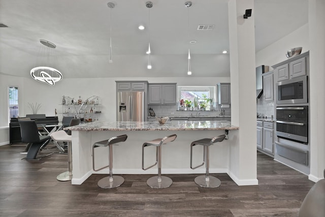 10108 Morning Glory Ln, Frisco, TX 75035 - kitchen featuring appliances with stainless steel finishes, gray cabinetry, a warming drawer, backsplash, and recessed lighting