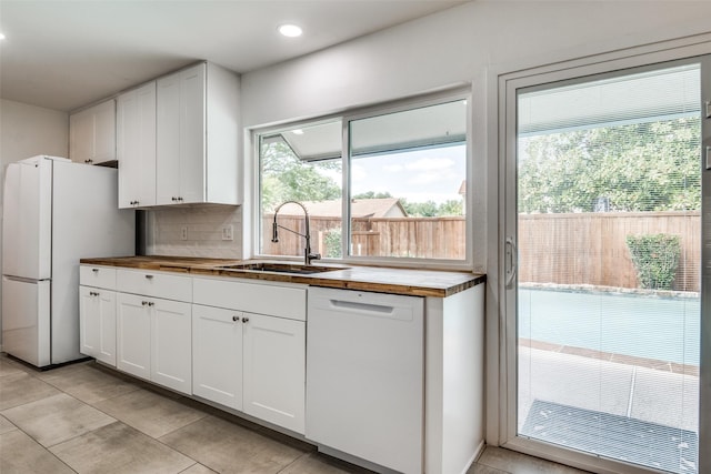 3301 Regent Dr, Plano, TX 75075 - kitchen featuring a sink, white appliances, wooden counters, white cabinetry, and recessed lighting