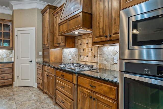 5524 Hollytree, Tyler, TX 75703 - kitchen featuring stainless steel appliances, crown molding, tasteful backsplash, and brown cabinets